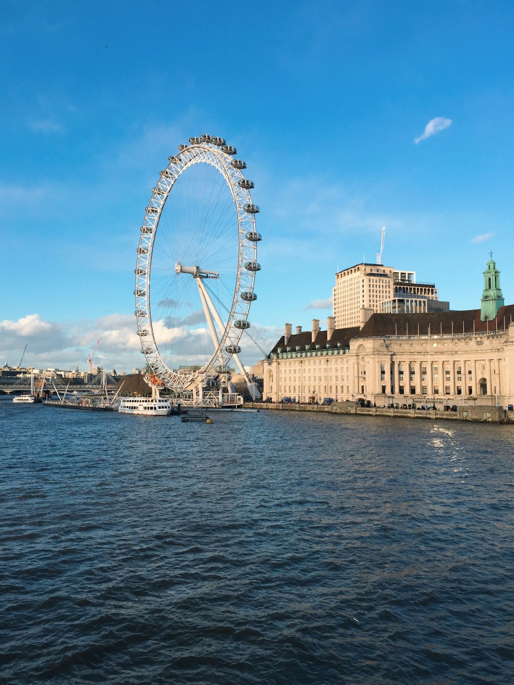 white ferris wheel near calm water