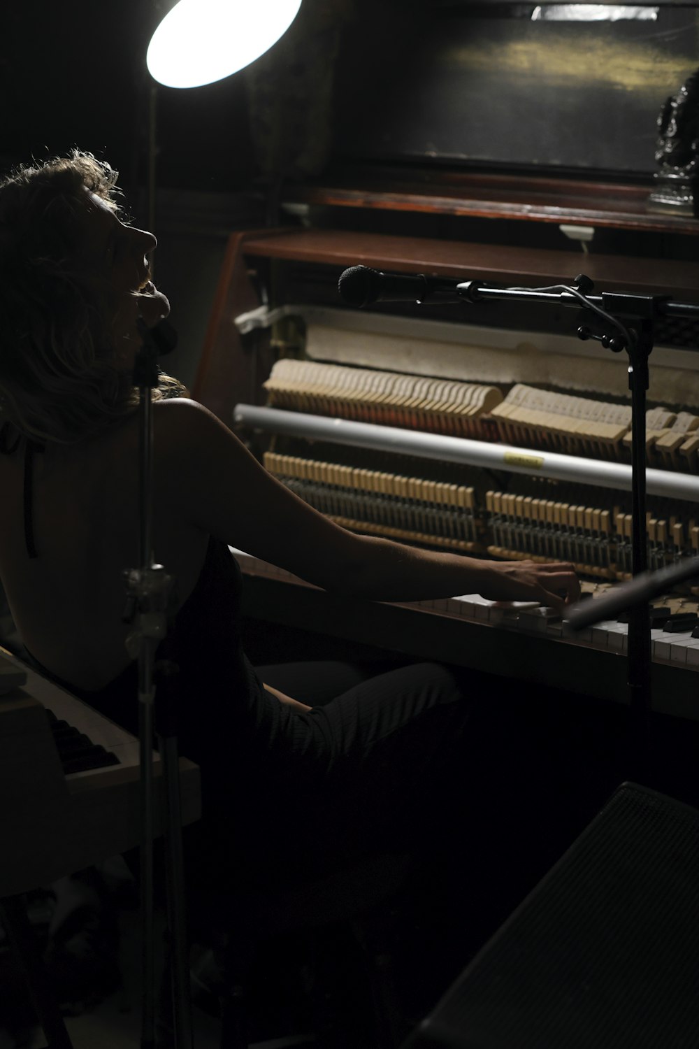 a woman sitting in front of a piano