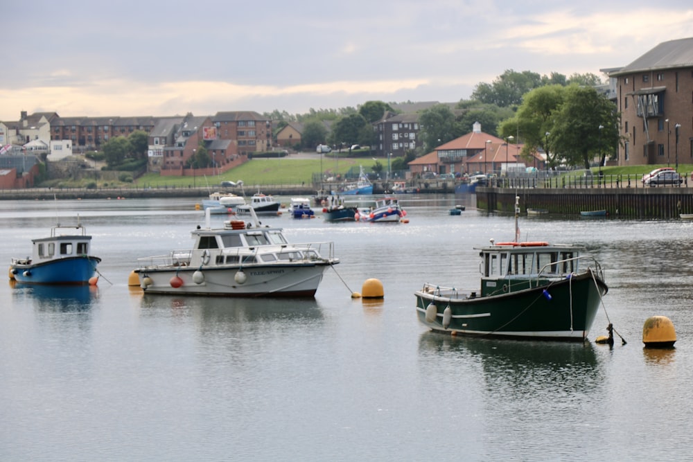 three boats at the river during daytime