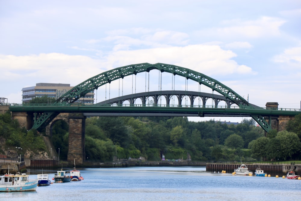 a bridge over a body of water with boats in it