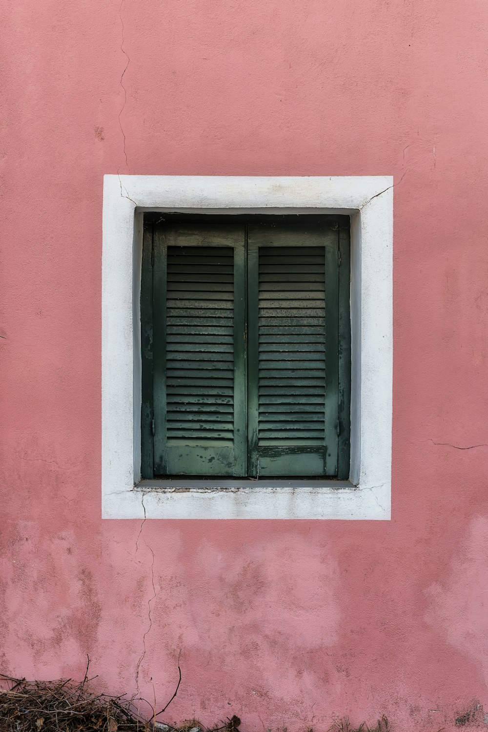 two green wooden louvered doors