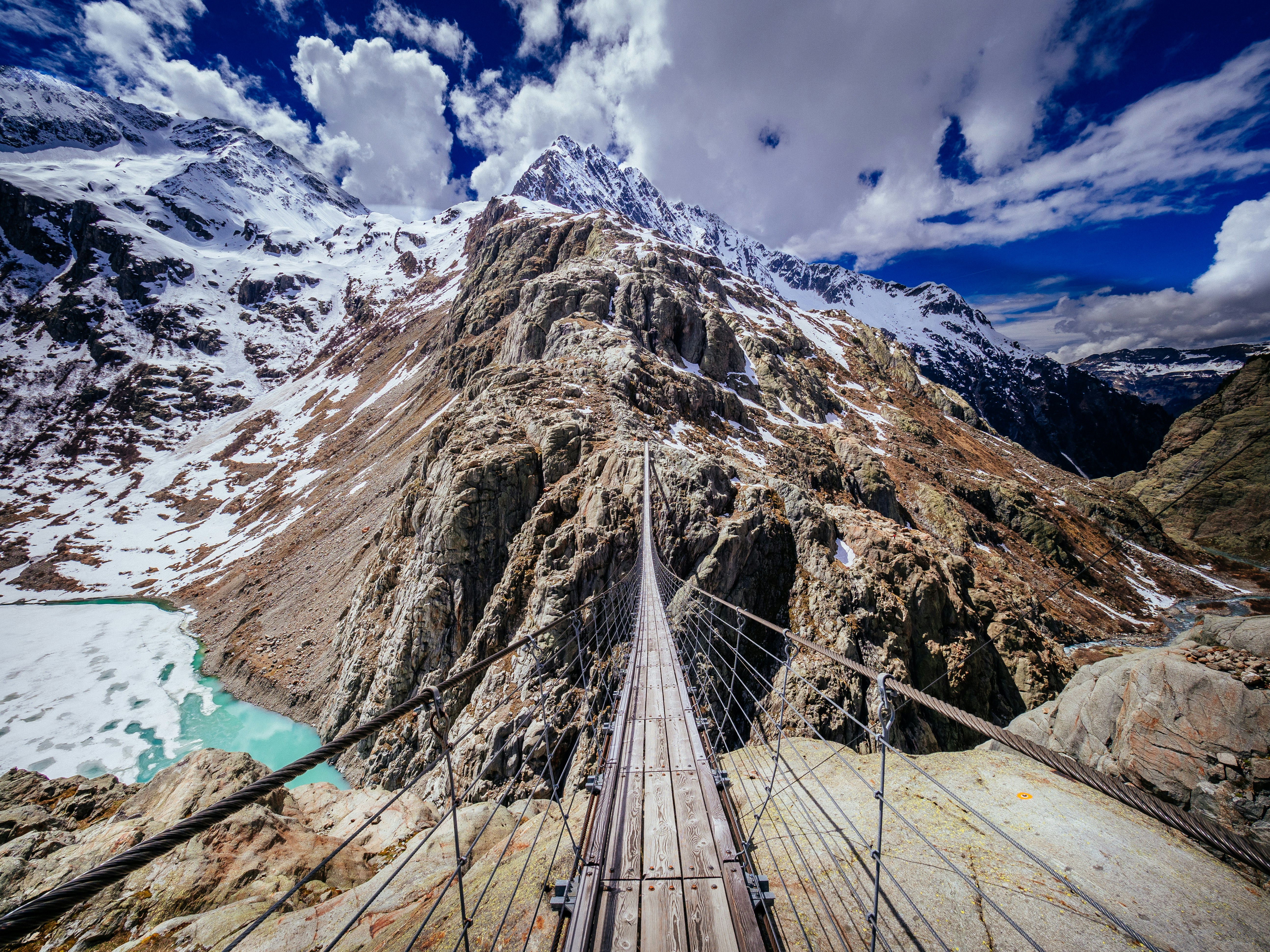 aerial photography of bridge and mountain range during daytime
