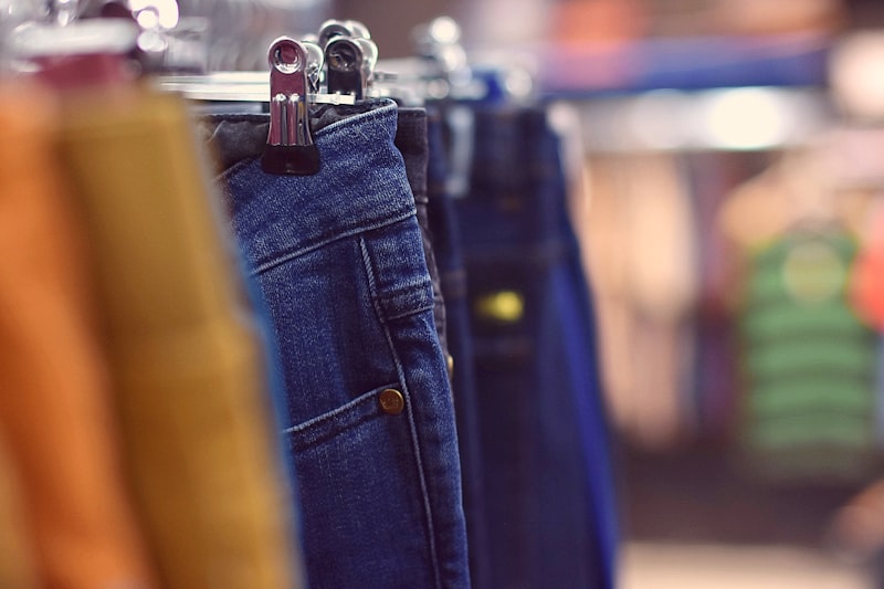 Denim jeans hanging on a retail display rack in a clothing store