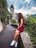 woman sitting on concrete wall near a cathedral