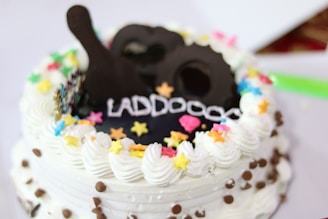 A beautifully decorated chocolate cake with vibrant sprinkles on top.