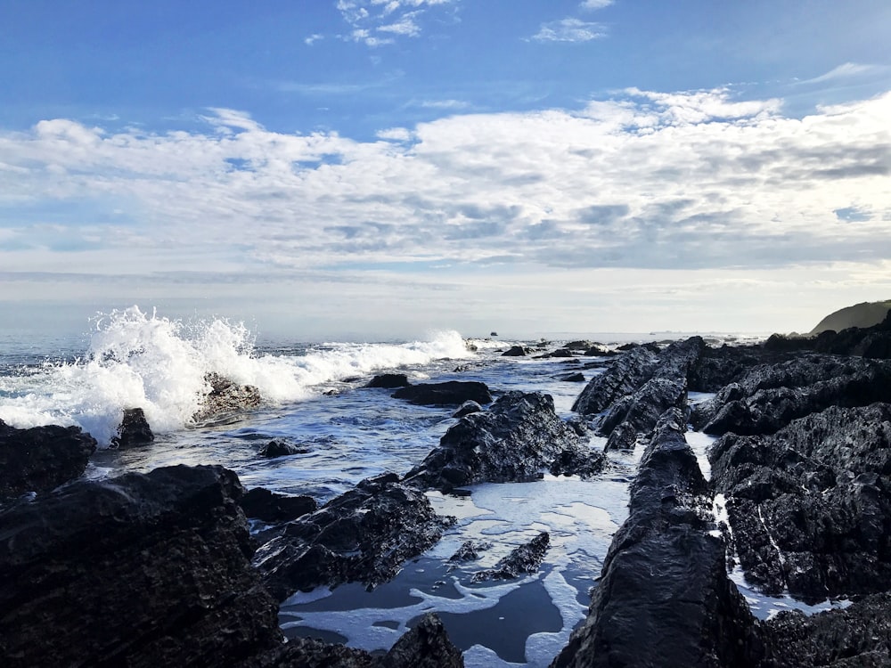 ocean waves crashing on stone
