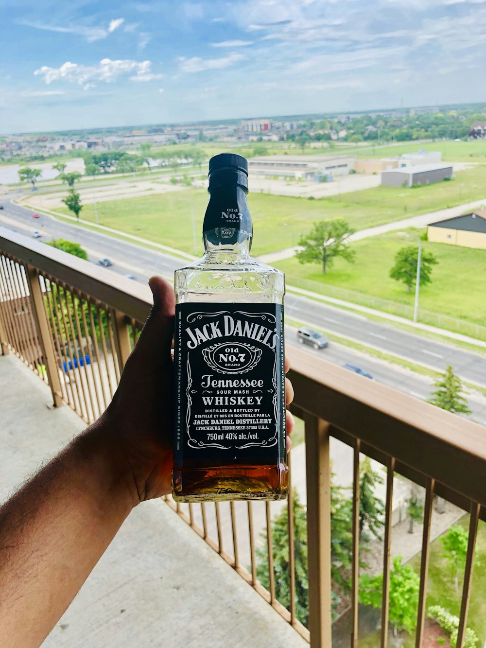 person holding Jack Daniels whisky bottle