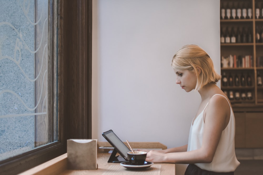 lady in white top doing a task