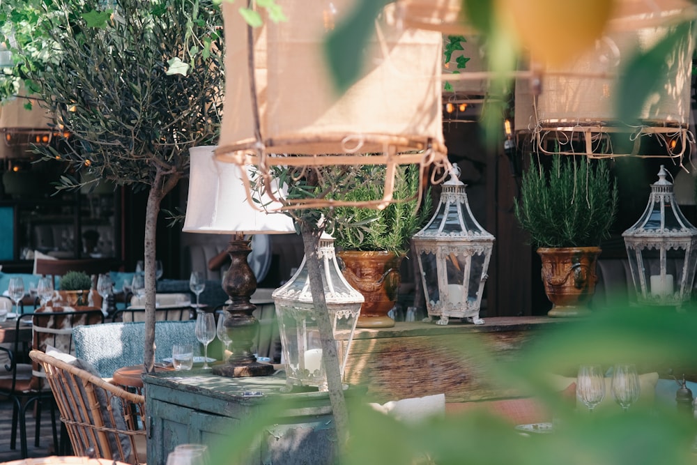 a table topped with lots of vases filled with plants