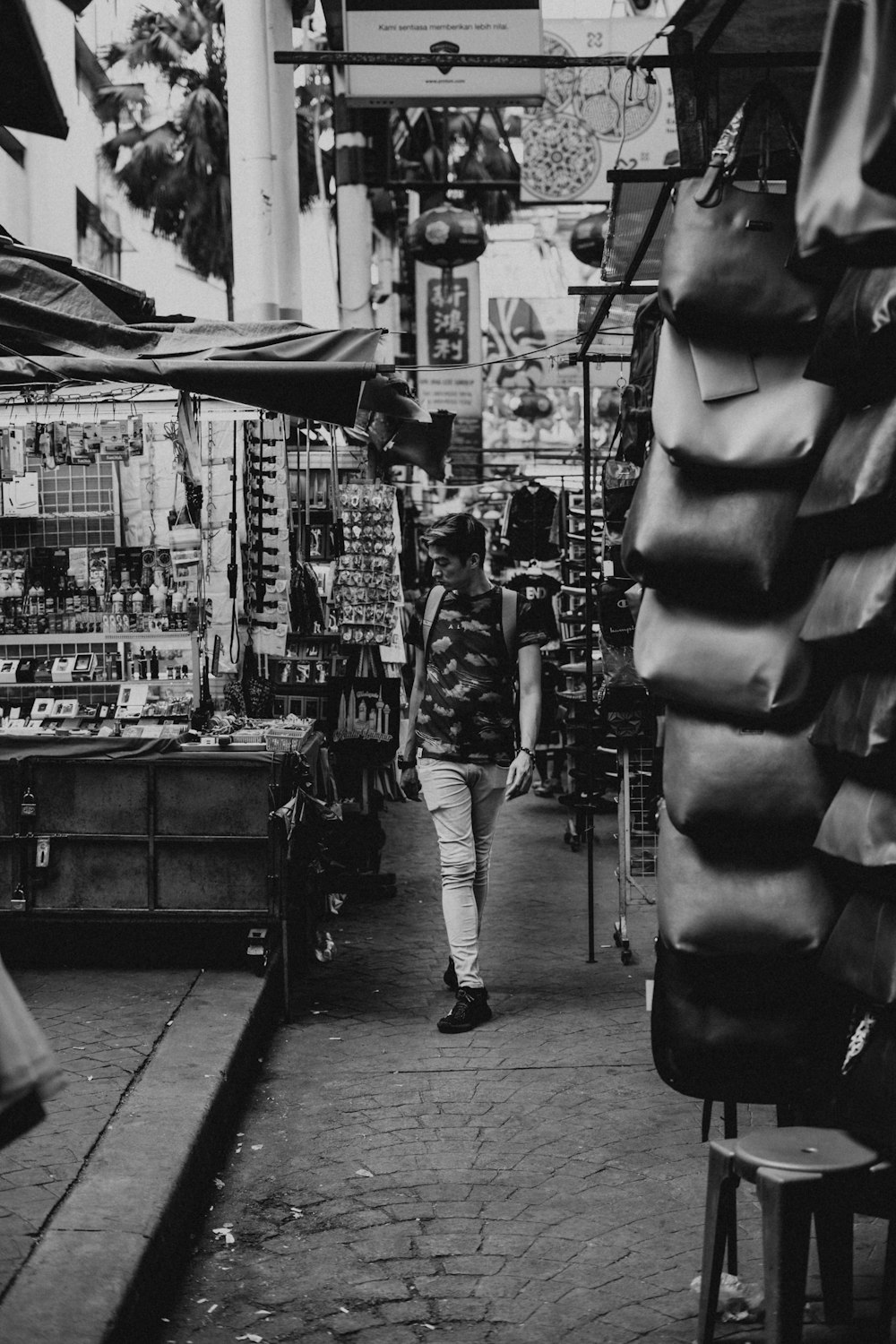 grayscale photo of man in market