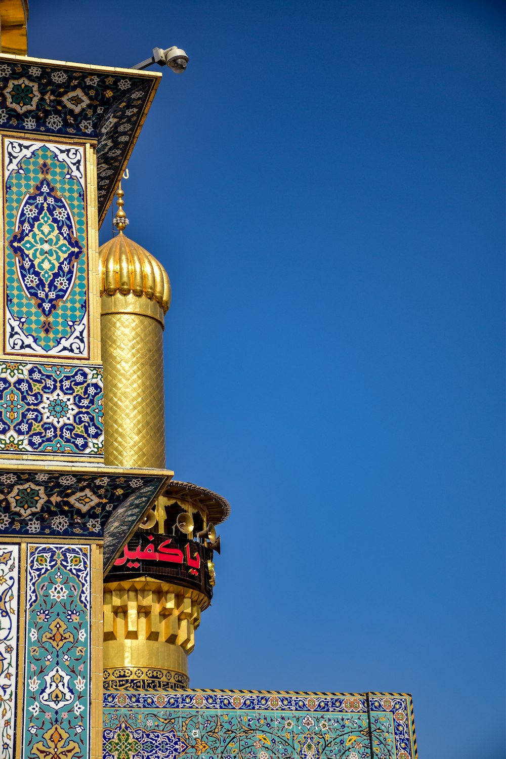 a tall building with a blue sky in the background