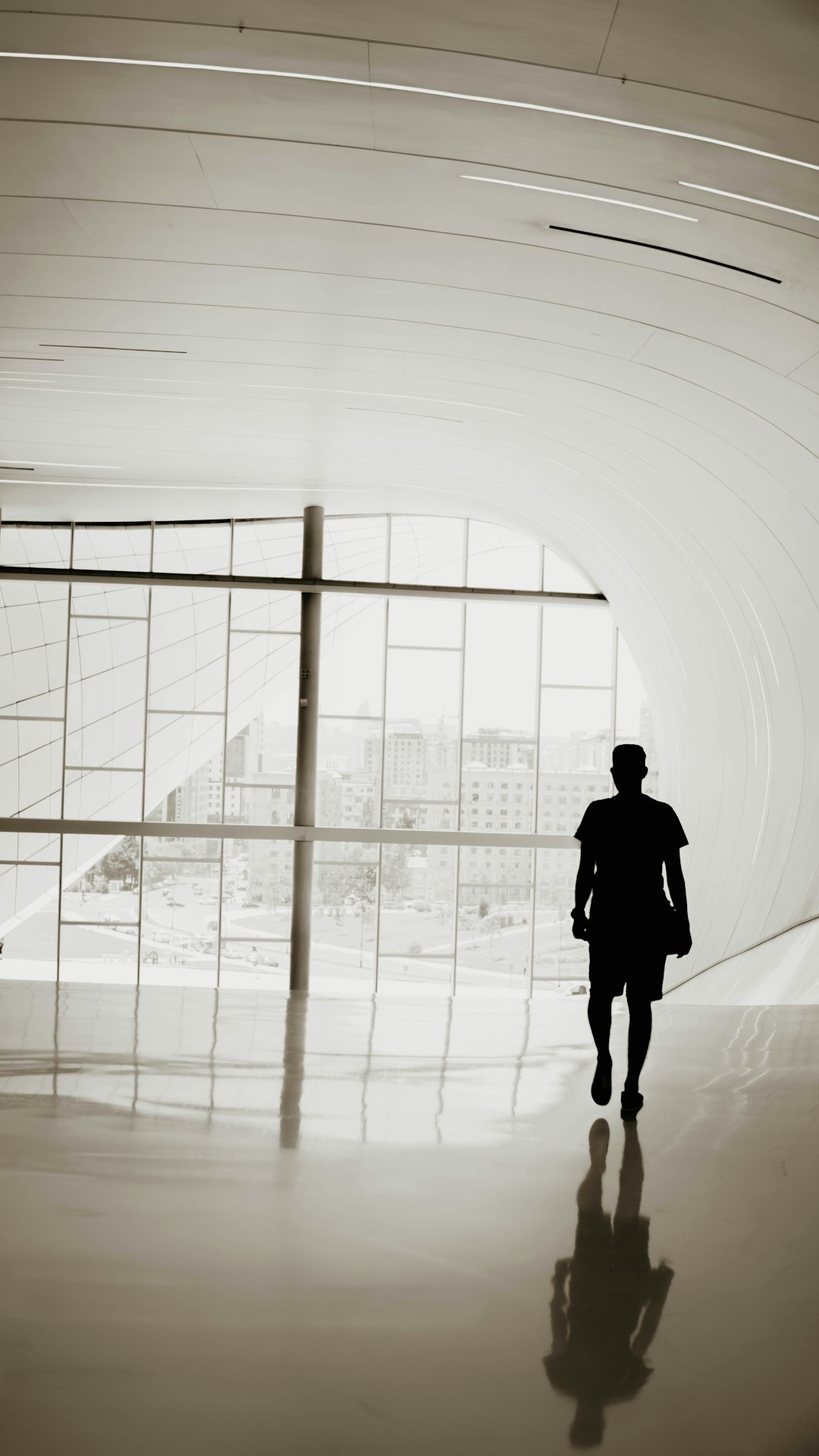 silhouette of person walking inside building
