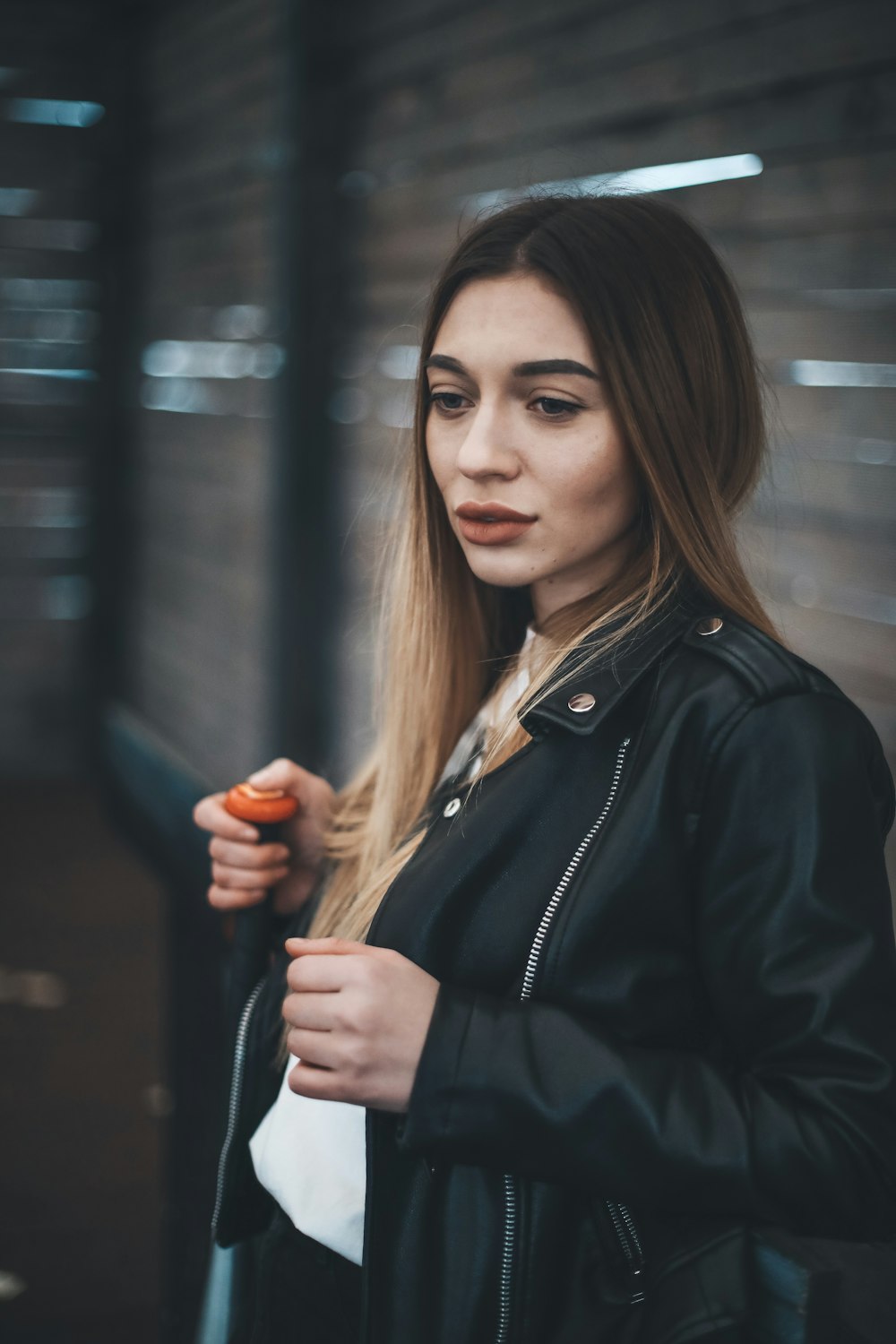 woman leaning against metal fence