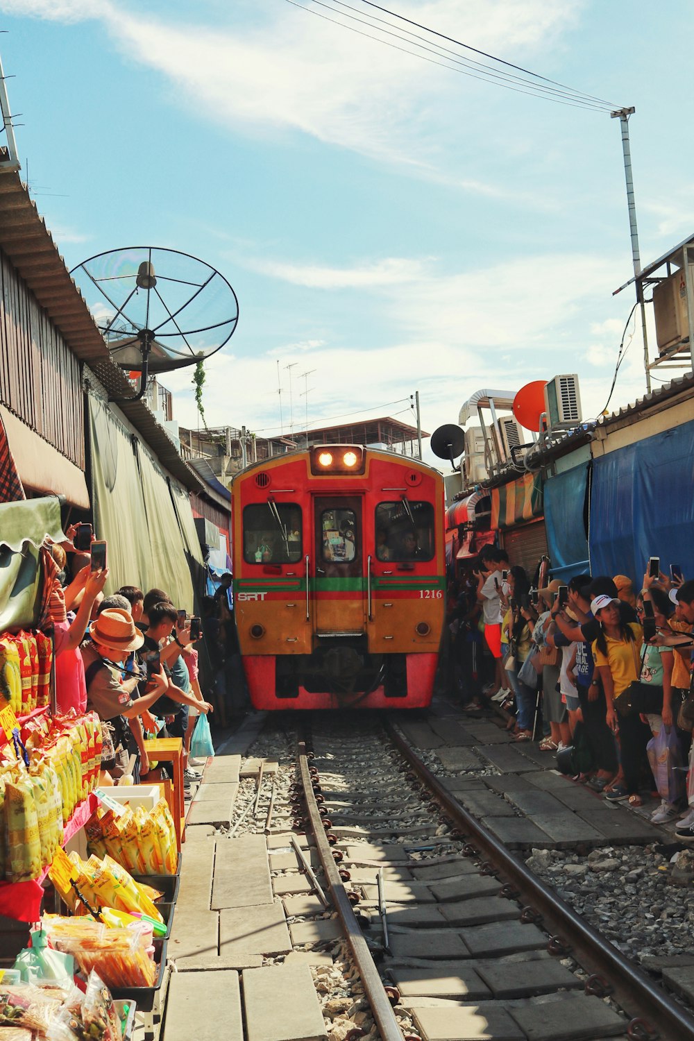 people near red train during daytime