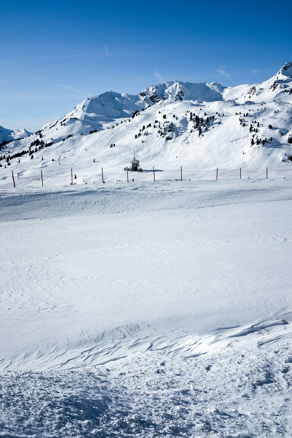 fence on snow during daytime