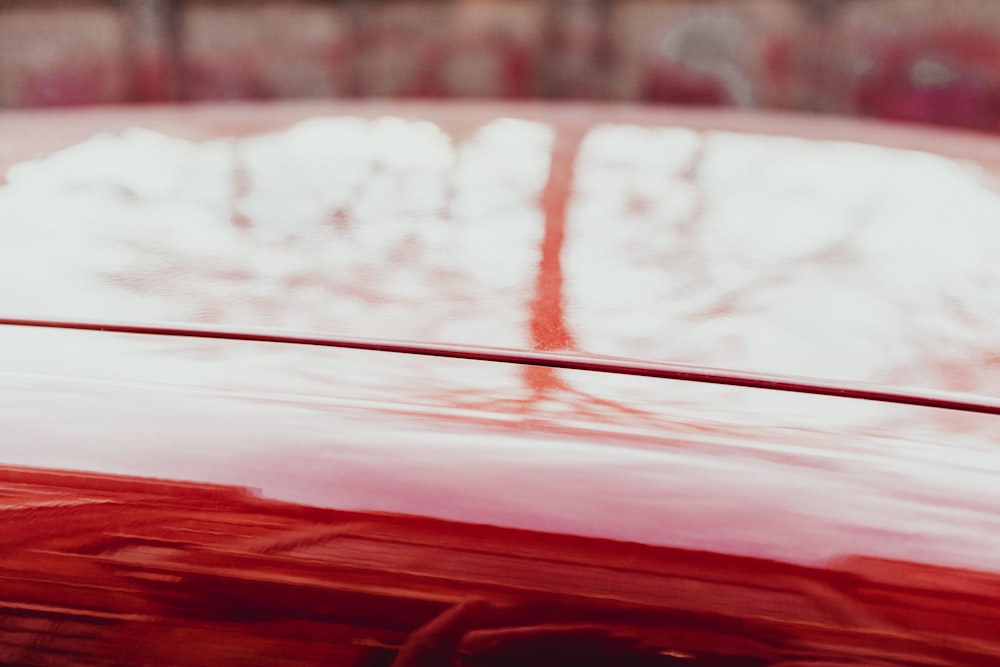 a close up of the hood of a red car