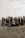 A diverse group of volunteers participating in a beach cleanup.