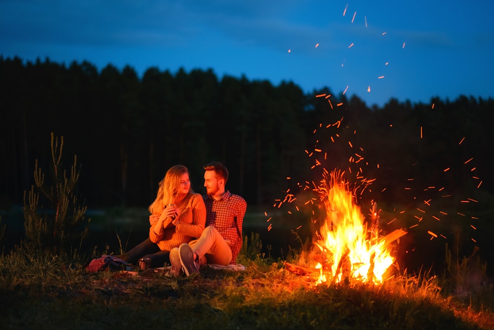 two person near bonfire during daytime