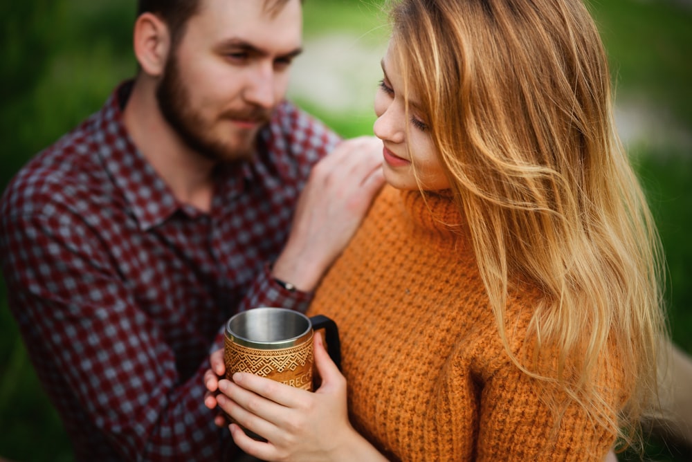 a man and a woman holding a coffee mug