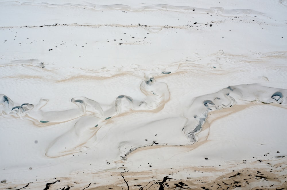 an aerial view of sand and water in the ocean