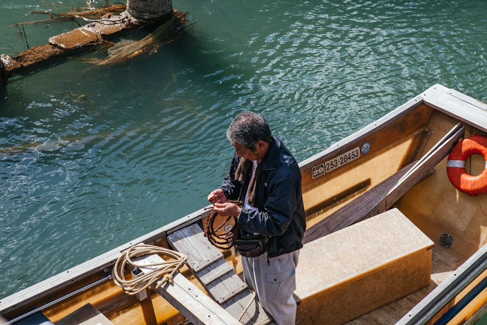 man wearing black jacket standing on boat