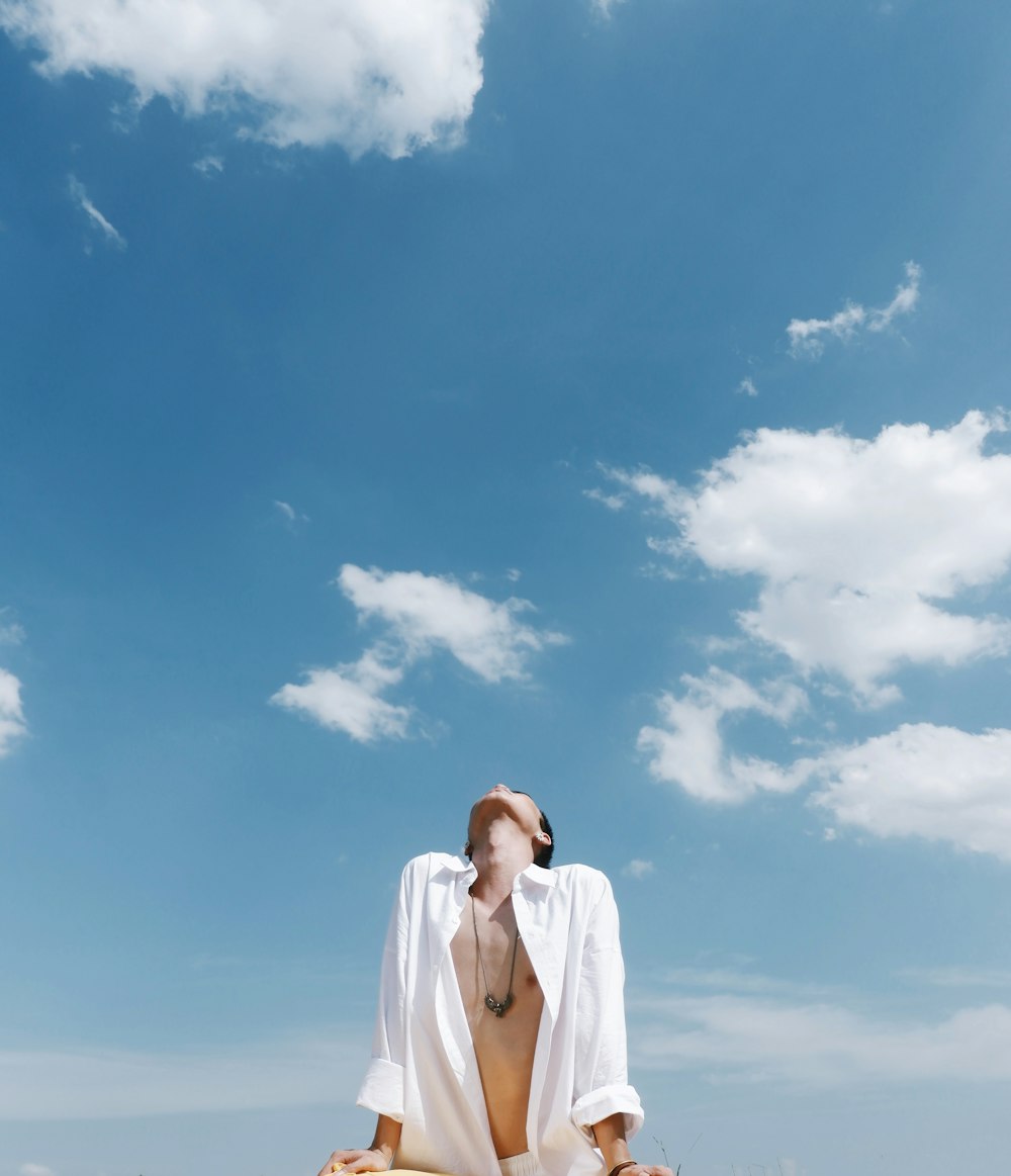 man wearing white dress shirt looking up