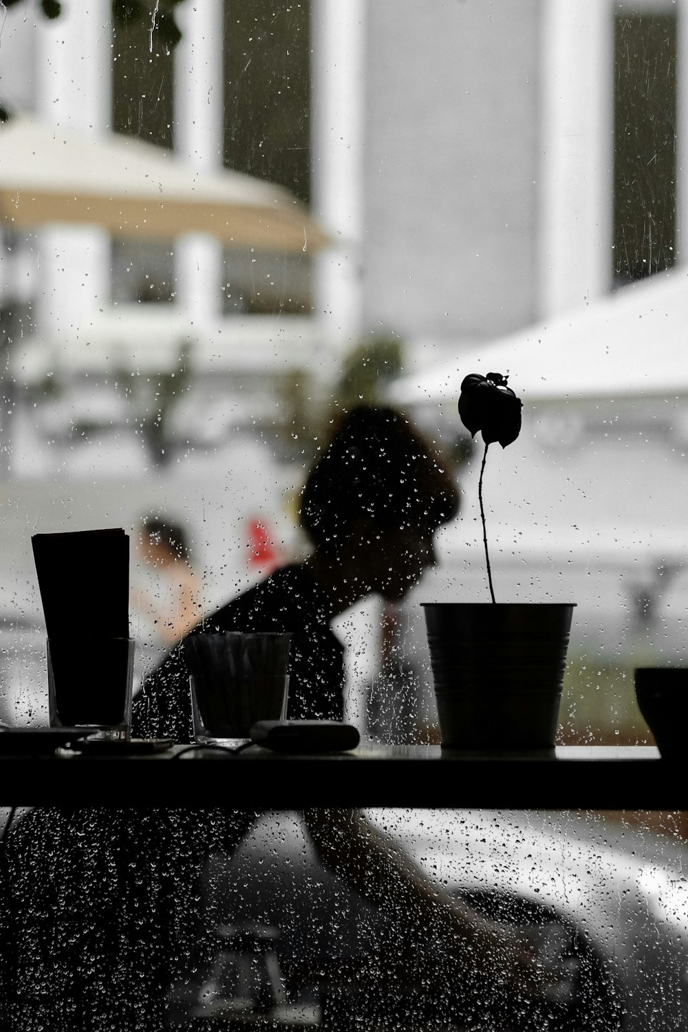 silhouette view of table near glass wall