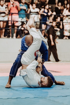 shallow focus photo of two man playing taekwondo