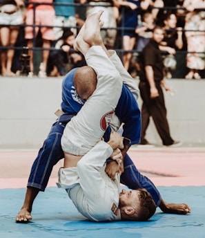 shallow focus photo of two man playing taekwondo