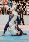 shallow focus photo of two man playing taekwondo