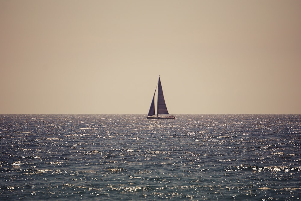 a sailboat in the middle of the ocean