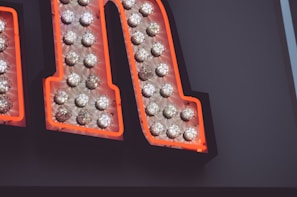 A close-up of a neon sign featuring unique lettering.