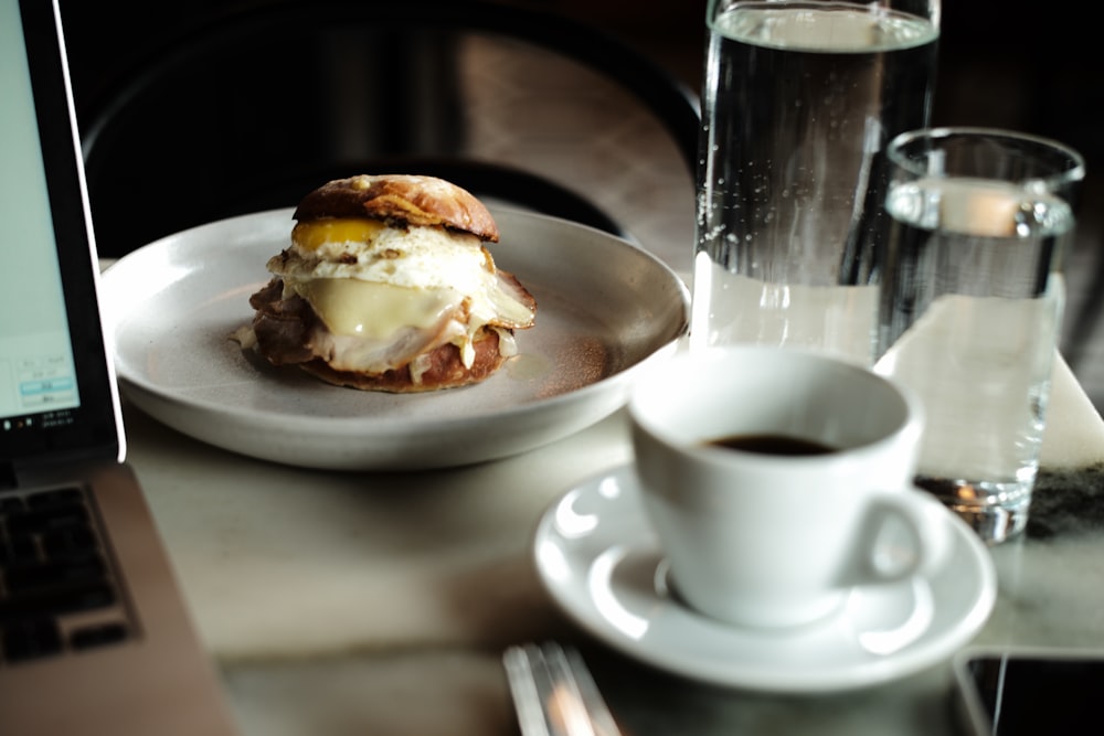 a plate of food and a cup of coffee on a table