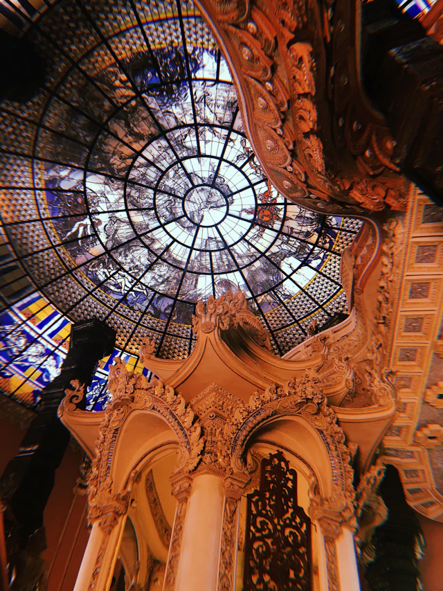 The ornate stained-glass dome and rococo columns inside the Erawan Museum's three-tiered tower.