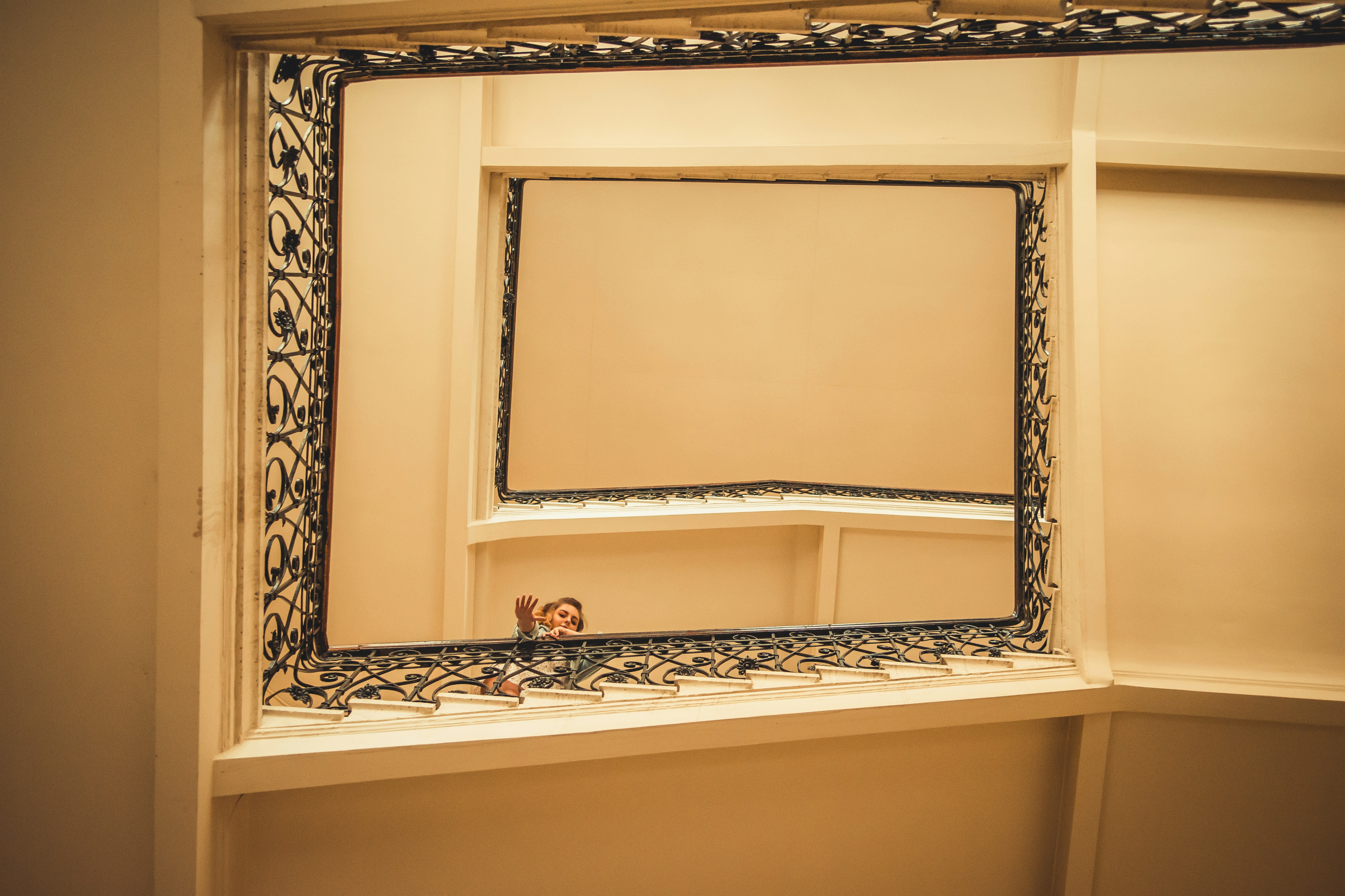 homeowner masking off cabinet frames with blue tape - best way to refinish kitchen cabinets without stripping