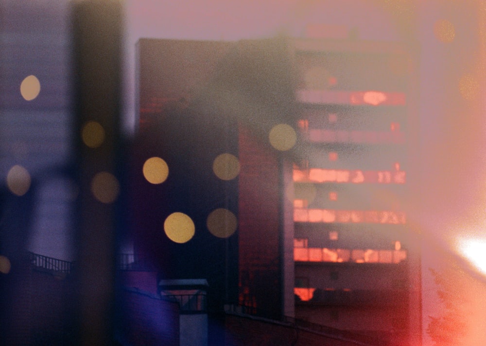 a blurry photo of a building with lights in the background