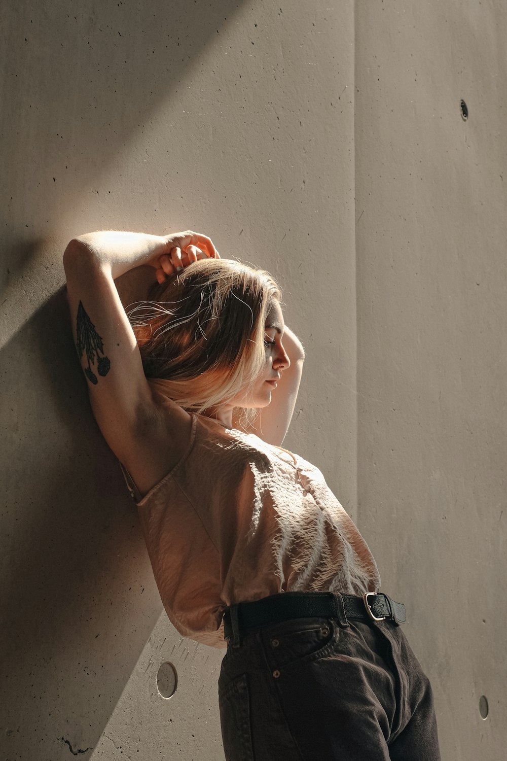 woman leaning on wall