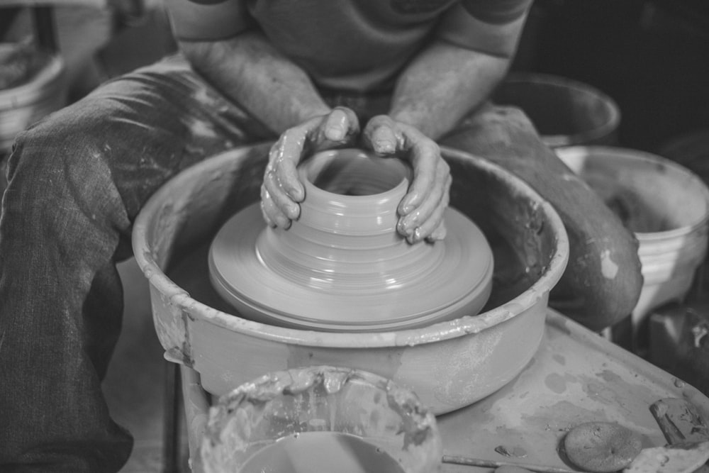closeup photo of man making clay pot