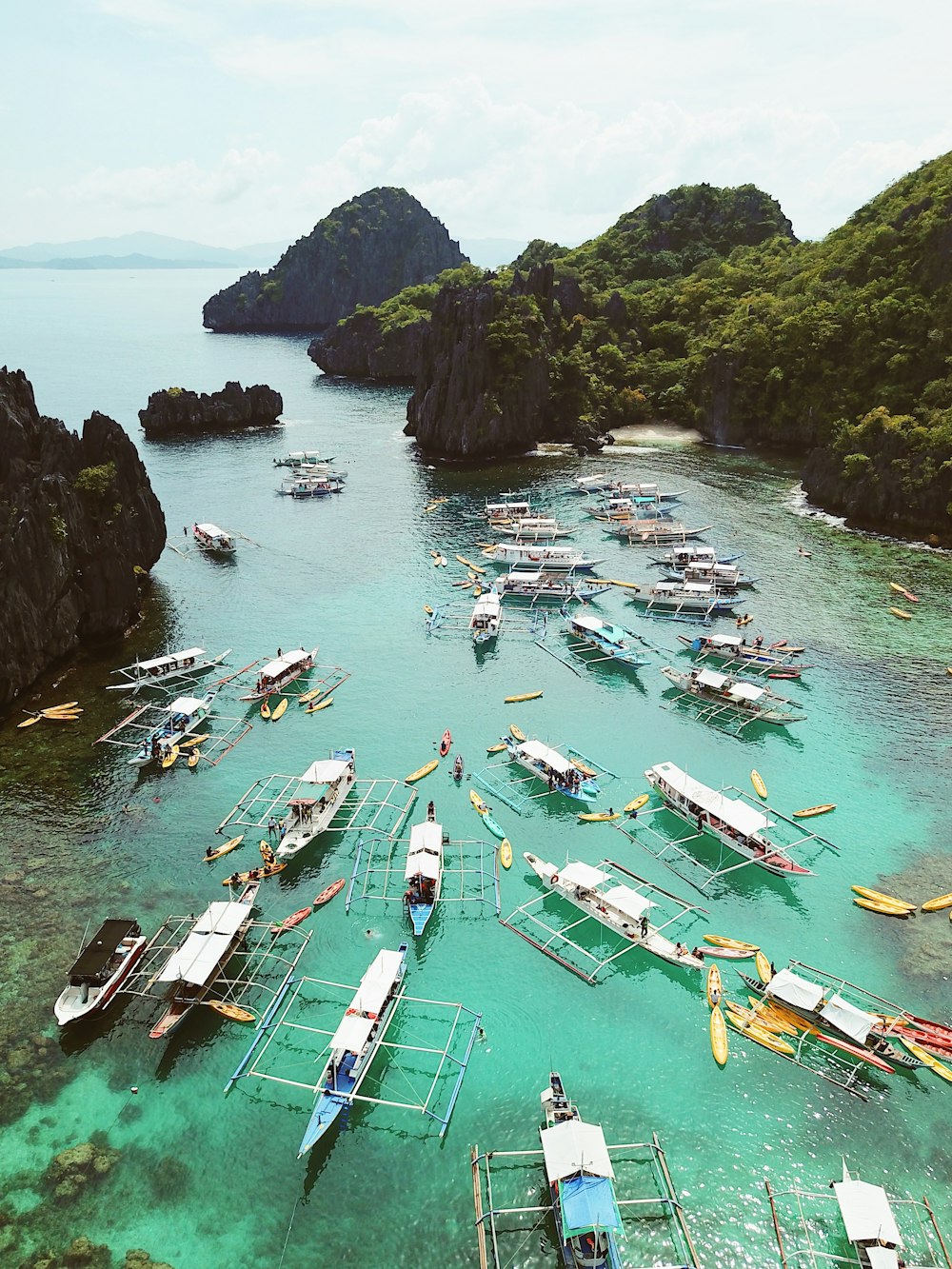 assorted-color boats on lake viewing islands