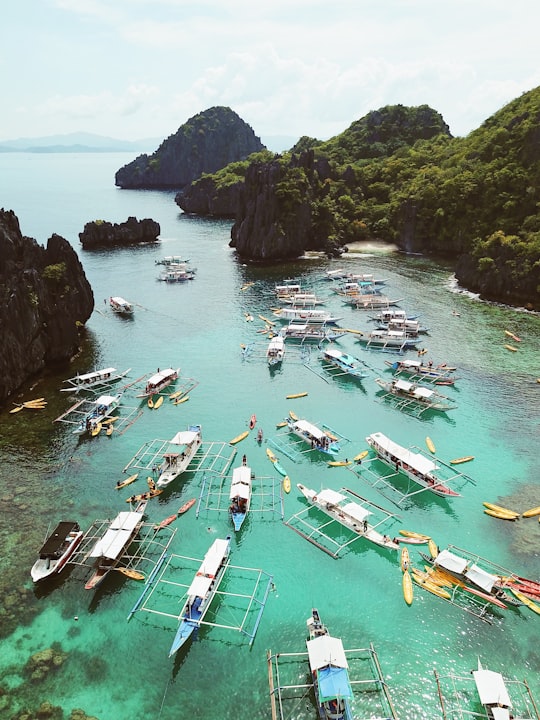 assorted-color boats on lake viewing islands in El Nido Philippines
