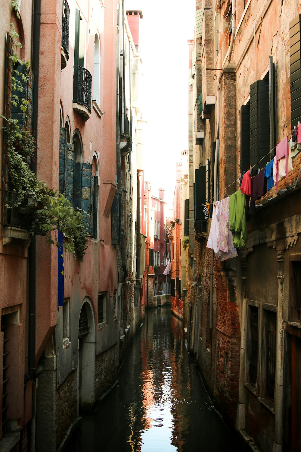 a canal runs through a narrow city area