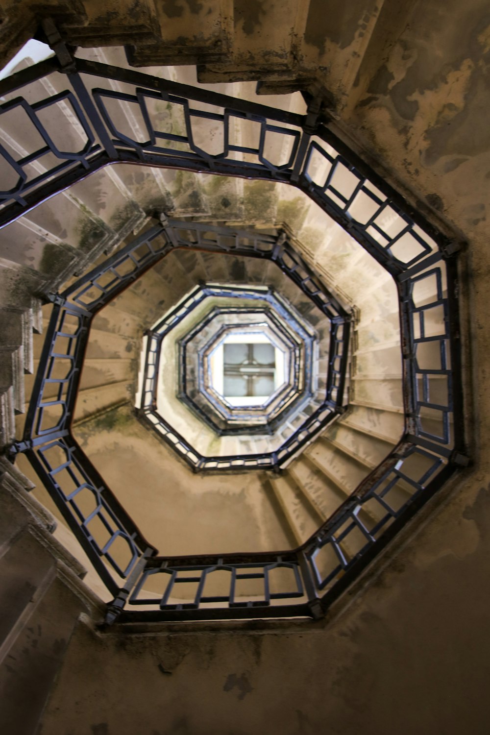 a spiral staircase with a skylight in the middle of it