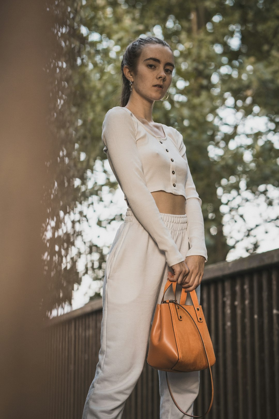 woman standing and holding bag