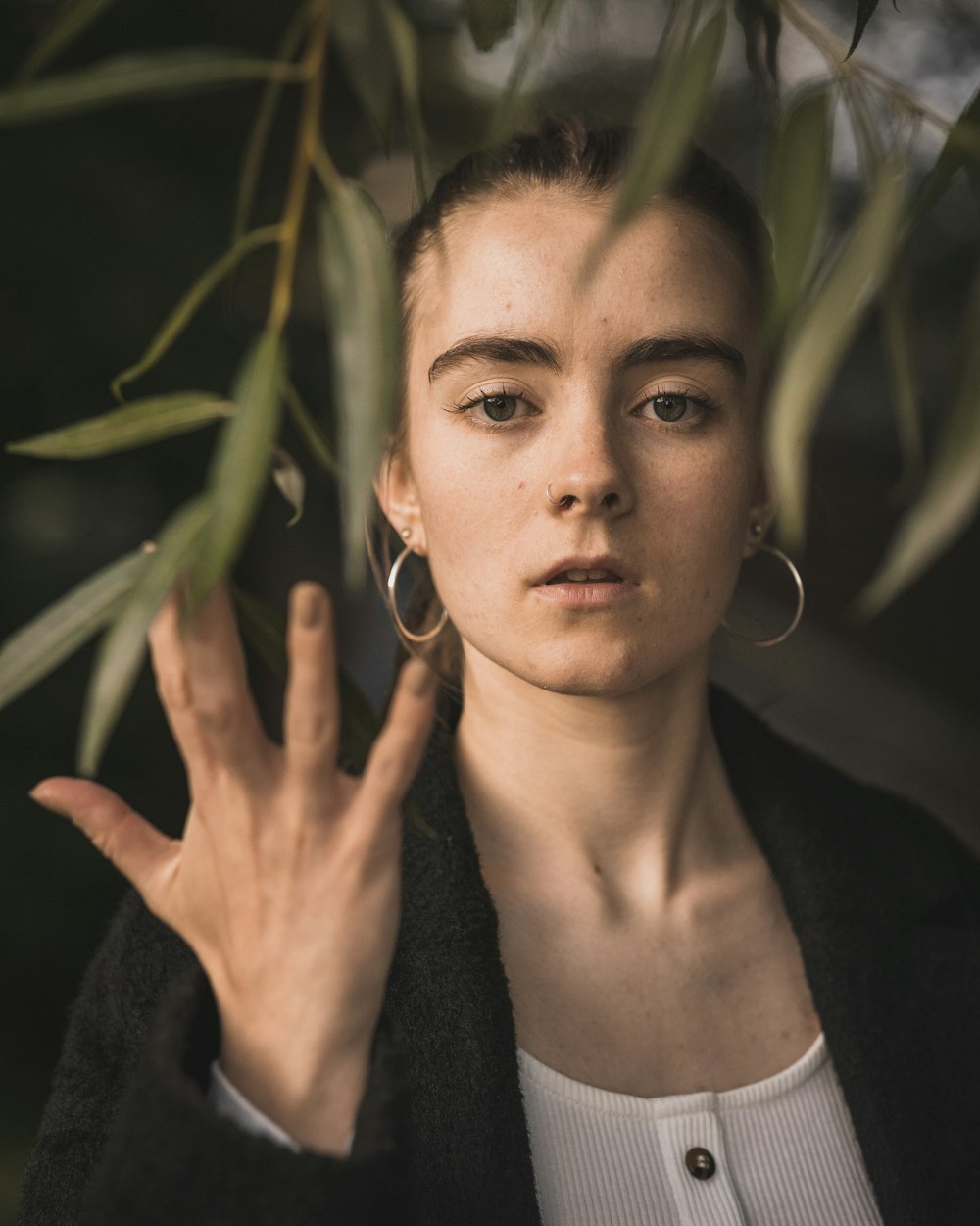 a woman is holding her hand up in front of her face