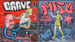 A vibrant graffiti-style mural featuring two distinct panels. The left panel shows a muscular man with sunglasses and a hat wrestling with a large, pink, tentacled monster. The background is a brick wall with bold text reading 'GRAVE.' The right panel portrays a stylized female character in a yellow outfit striking a confident pose, surrounded by blue-toned faces with large eyes. The text 'MIZU' and 'La Cyber Défendresse' are prominently displayed, with a red star featuring additional writing.