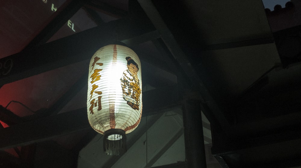 powered-on paper lantern hanging on ceiling