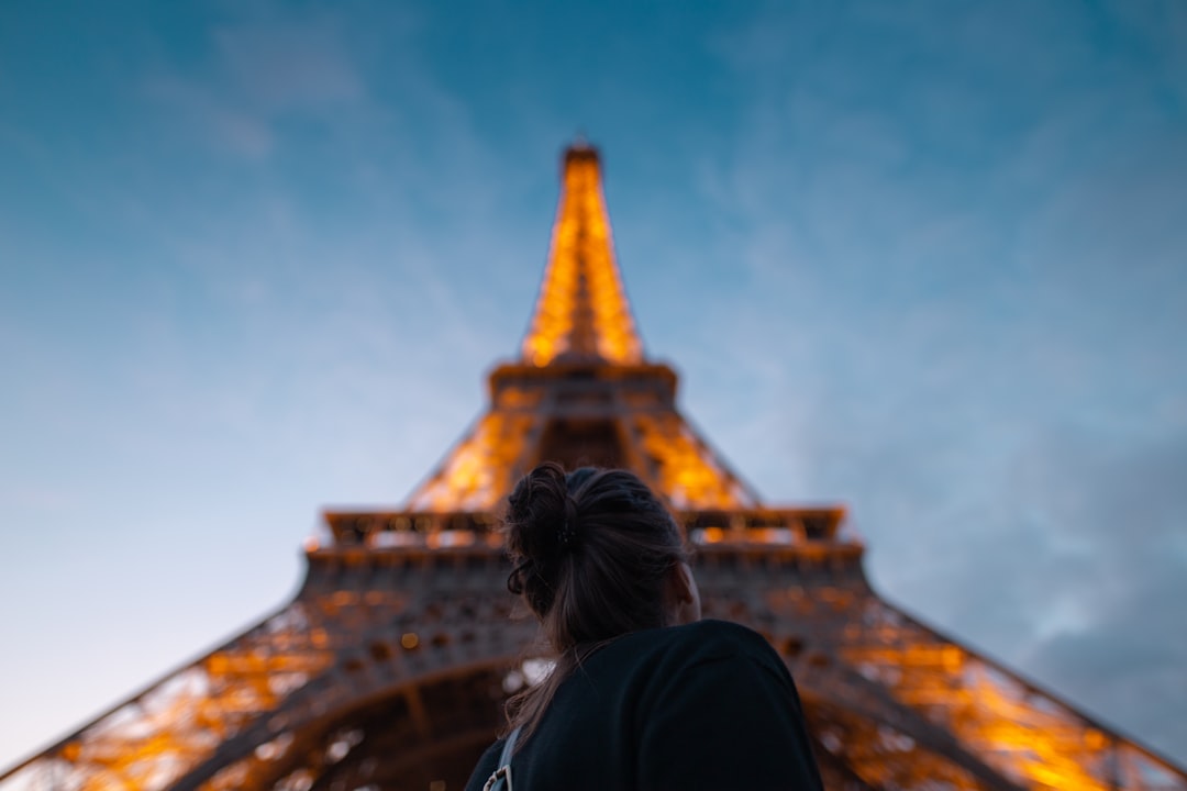 woman standing under Eiffel Tower