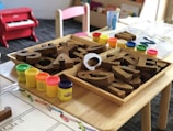 Kindergarten classroom table with wooden alphabet letters and play materials in Wellington early lea