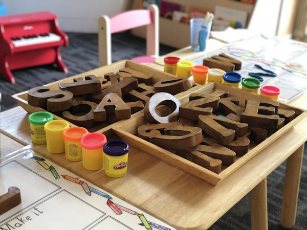 Wooden alphabet letters arranged on a table in an early childhood classroom
