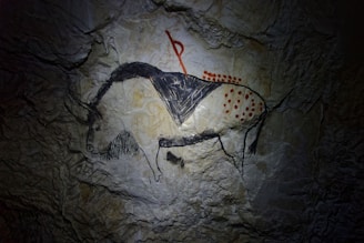a cave painting of a man riding a horse